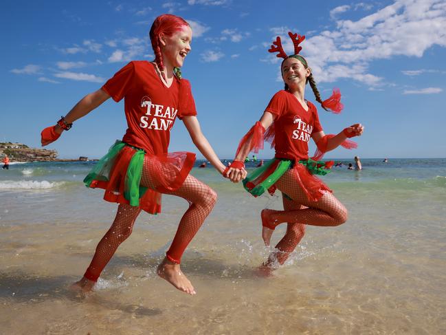 #teamsanta: Lillian Wenmohs, 11, and Mimi Tolnay, 11, enjoying Christmas on Bondi Beach. Picture: Justin Lloyd