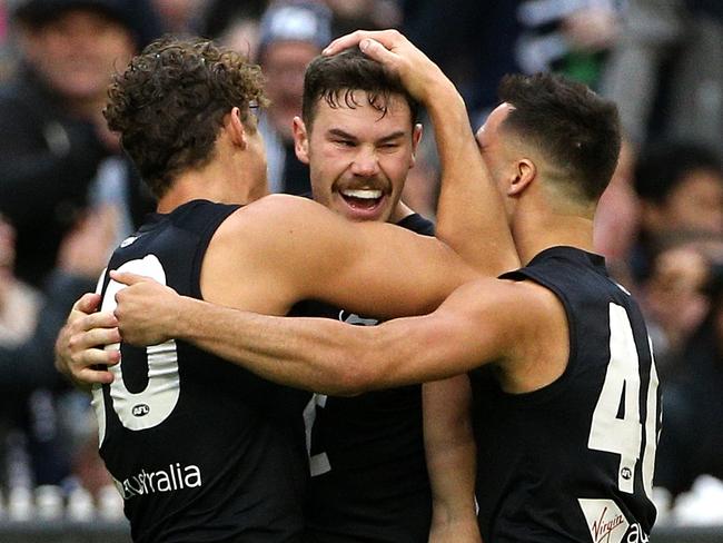 Mitch McGovern of the Blues (second from left) celebrates a goal with teammates during the Round 8 AFL match between the Carlton Blues and the Collingwood Magpies at the MCG in Melbourne, Saturday, May 11, 2019. (AAP Image/Hamish Blair) NO ARCHIVING, EDITORIAL USE ONLY