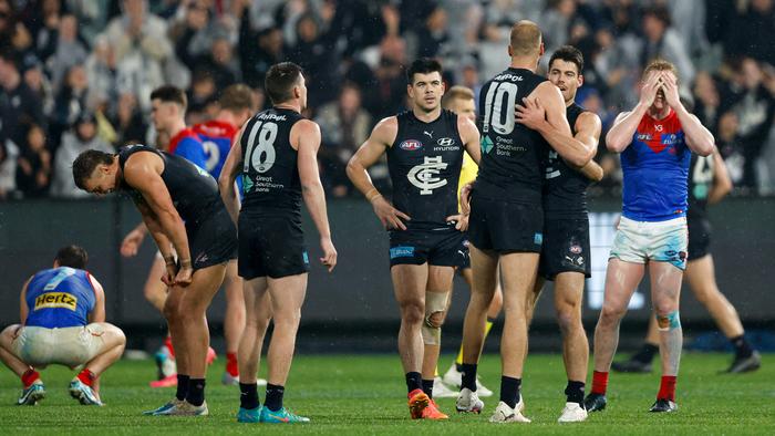 MELBOURNE, AUSTRALIA - MAY 09: Players react after the siren during the 2024 AFL Round 09 match between the Carlton Blues and the Melbourne Demons at The Melbourne Cricket Ground on May 09, 2024 in Melbourne, Australia. (Photo by Dylan Burns/AFL Photos via Getty Images)