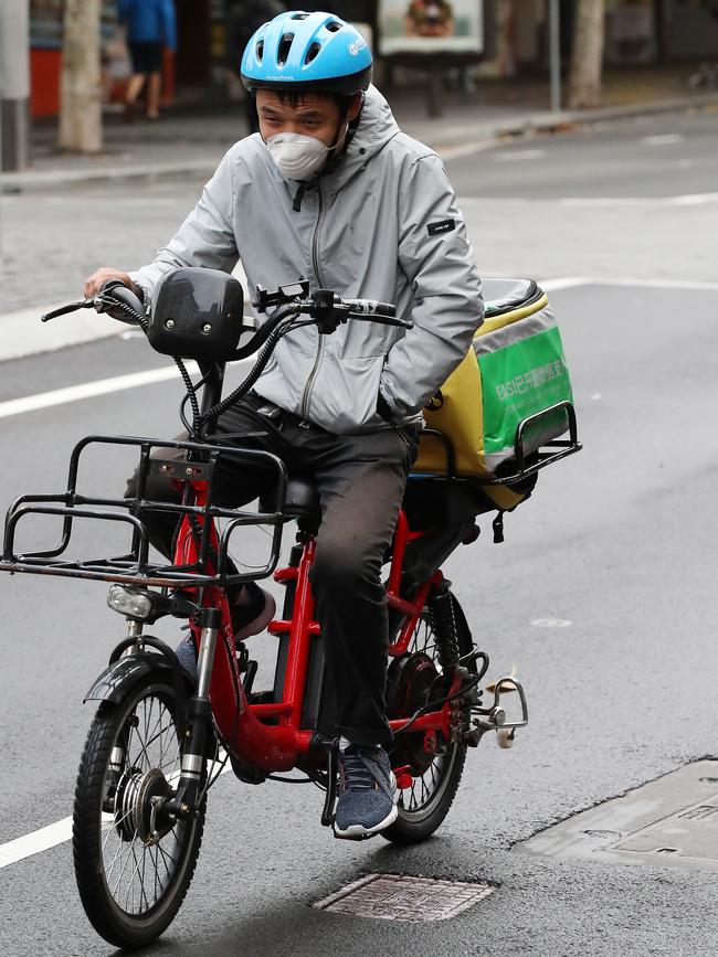 A food delivery bike rider in Sydney today. Picture: David Swift