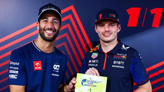 Daniel Ricciardo of Australia and Scuderia AlphaTauri presents Max Verstappen of the Netherlands and Oracle Red Bull Racing with the Number 1 for the Wings for Life World Run 2024 during previews ahead of the F1 Grand Prix of United States. Picture: Getty