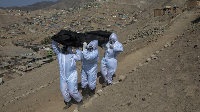 The body of a coronavirus victim is removed on the outskirts of Lima, Peru. Picture: AP