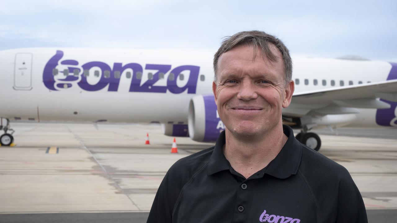 Bonza CEO Tim Jordan stands in front of the low-cost airline's first plane at Sunshine Coast Airport ahead of its launch.