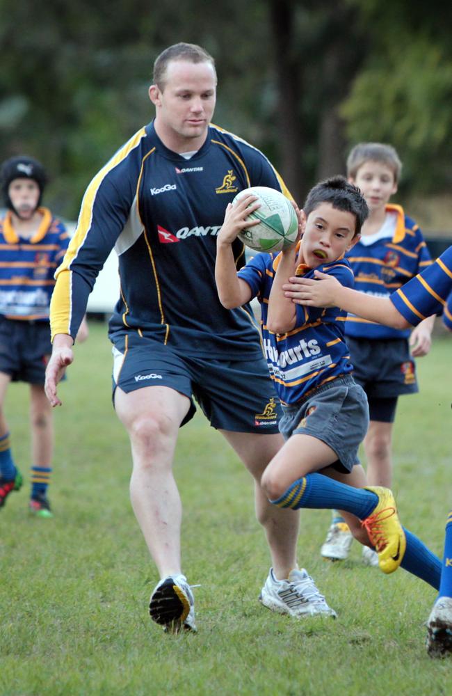 Wallaby player Richard Brown with 10-year-old Easts Tigers Fletcher Spicer.