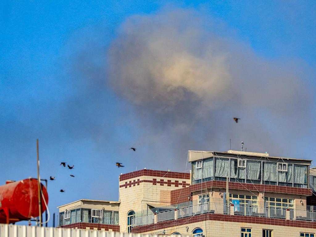 A smoke cloud billows after an air strike on Yemen's Huthi-held capital Sanaa on December 31, 2024. (Photo by Mohammed HUWAIS / AFP)