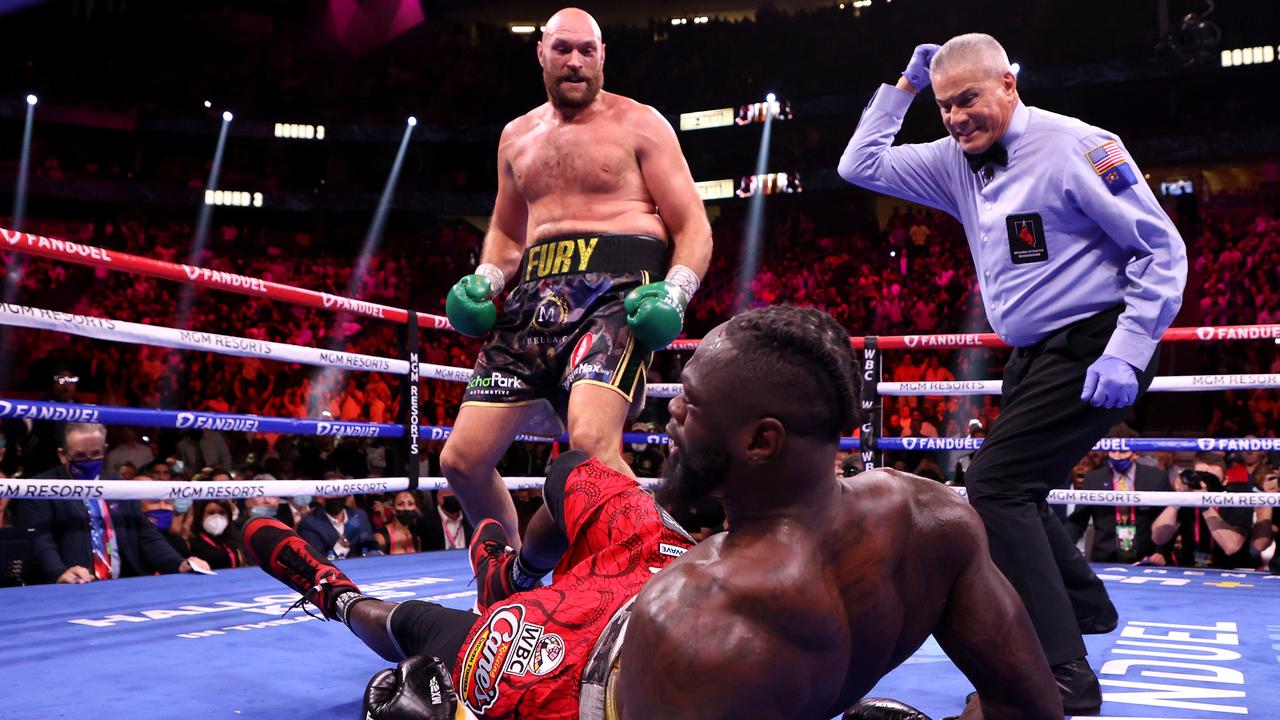 LAS VEGAS, NEVADA - OCTOBER 09: Deontay Wilder (C) is knocked down by Tyson Fury in the third round of their WBC Heavyweight Championship title fight at T-Mobile Arena on October 09, 2021 in Las Vegas, Nevada. (Photo by Al Bello/Getty Images)