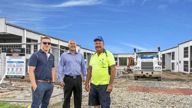 WIDE APPEAL: Jack Williams, left, with Rob Makara, right, and Glen Grimish of CBRE at Equinox Place, Bells Creek.