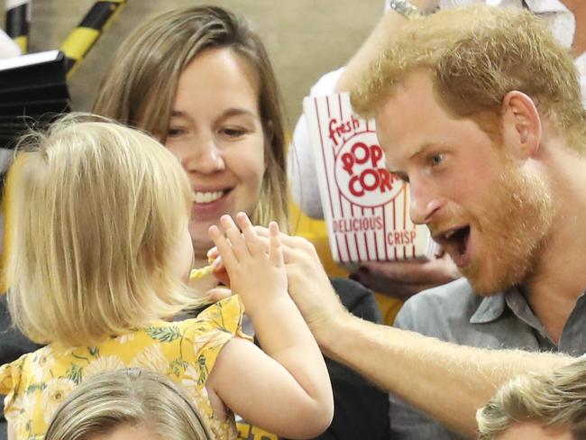 ... but he gives in and shares some with his new little mate. Picture: Chris Jackson/Getty Images for the Invictus Games Foundation