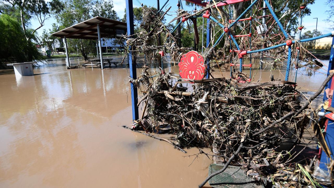 Play equipment is covered in debris and surrounded by flood water in Dalby, Queensland. Picture: AAP Image/Dan Peled