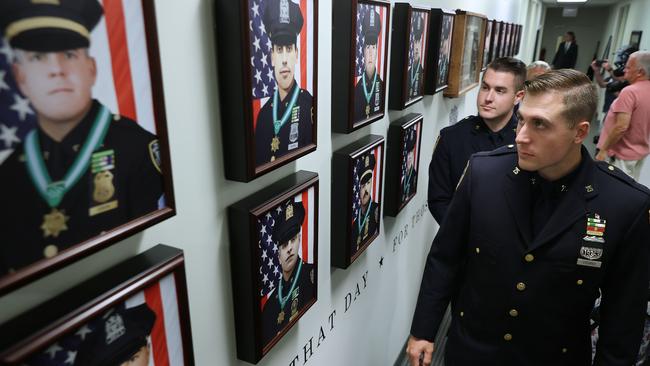 Brothers and NYPD Officers James Vigiano (L) and Joseph Vigiano Jr. at the 9/11 Memorial Wall at the Police Benevolent Association of the City of New York. Picture: AFP.