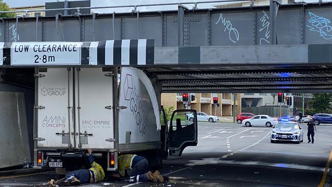 The truck hit a rail bridge near Indooroopilly station.