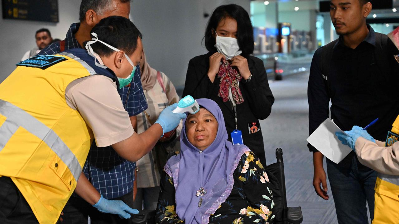 Health officials check the temperature of an Indonesian woman at Sukarno-Hatta international airport. Picture: Adek Berry/AFP