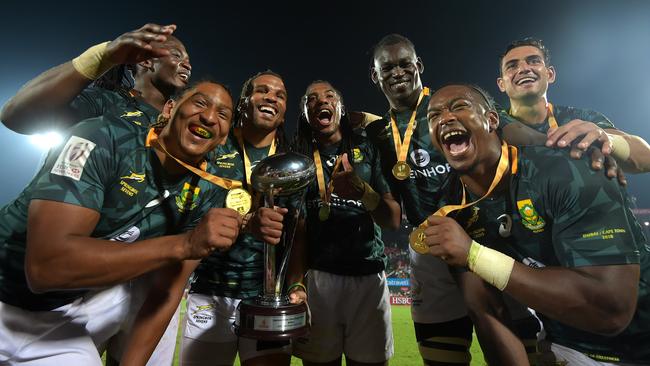 South Africa celebrate beating New Zealand in the final of the Dubai Sevens.