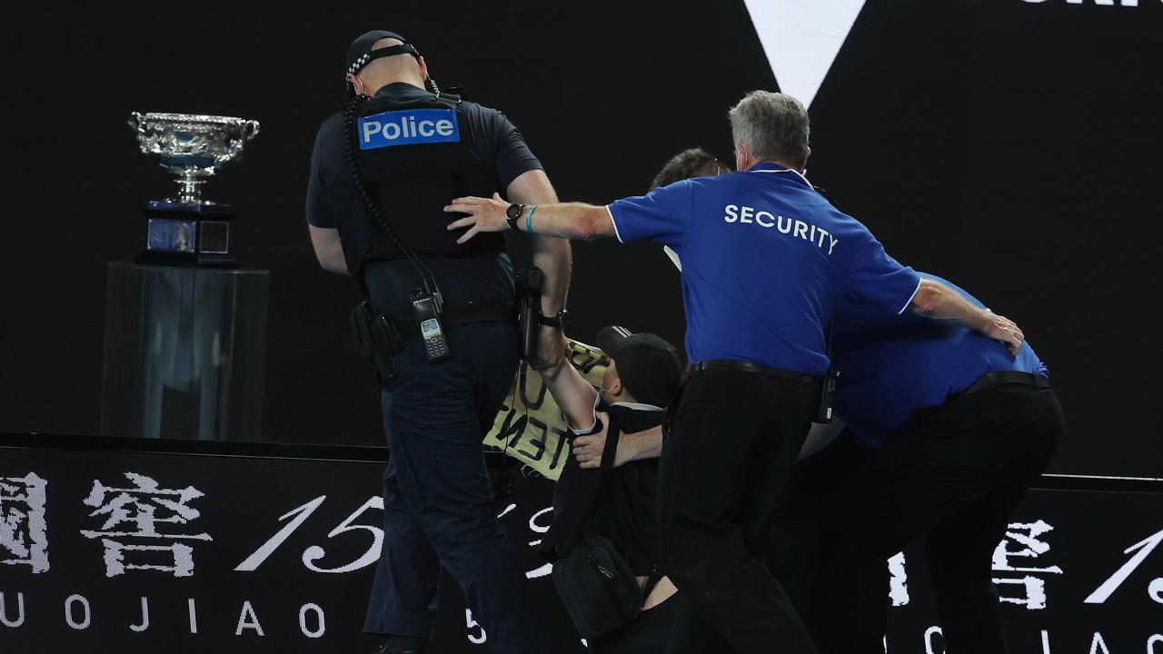 Police then dragged them off the court as the crowd watched on. Picture: Michael Klein