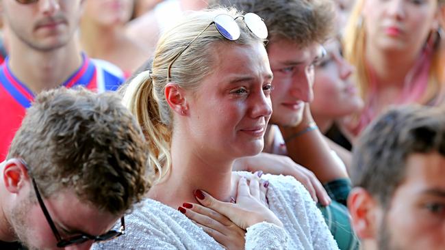 Vigil for Parisian Terror Victims at Federation Square, Melbourne, Australia. French Flags fly at half mast as people have the peace symbol adaption sprayed onto their clothing. Picture: Tim Carrafa