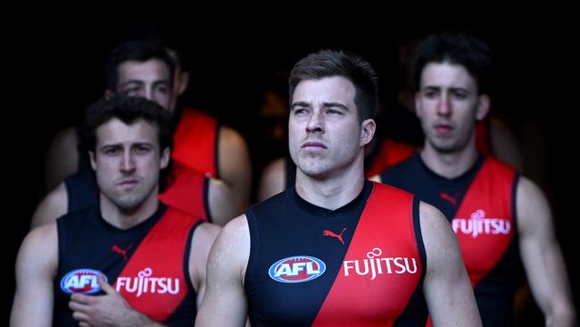 GEELONG, AUSTRALIA - FEBRUARY 25: Zach Merrett of the Bombers leads his team out onto the field during the 2025 AAMI AFL Community Series match between Geelong Cats and Essendon Bombers at GMHBA Stadium on February 25, 2025 in Geelong, Australia. (Photo by Quinn Rooney/Getty Images)