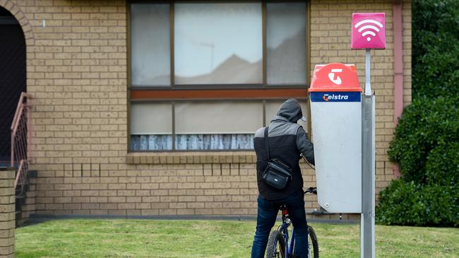 A man seen using a phone box believed to be used for drug deals in the area. Picture: Penny Stephens