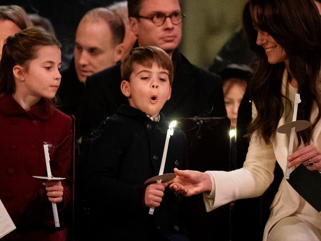 Princess Charlotte, Prince Louis blowing out his candle and Catherine during the Royal Carols – Together At Christmas service at Westminster Abbey last year. Picture: Getty Images