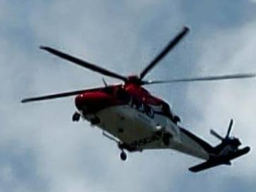 Rescue 510 helicopter flying over Cairns' southern suburbs.