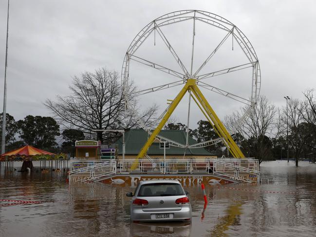 The ferris wheel at Camden Showground is partially underwater. Picture: Jonathan Ng