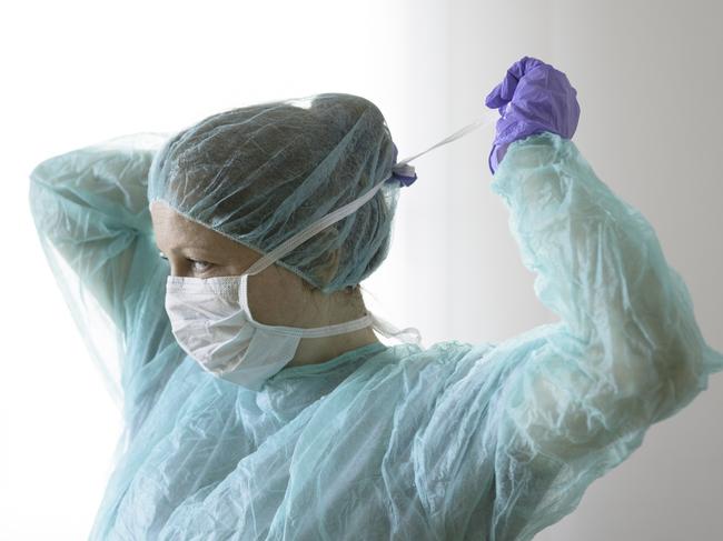 Nurse wearing protective mask and gloves. New coronavirus Covid-19 from China. Female surgeon wearing her surgical mask