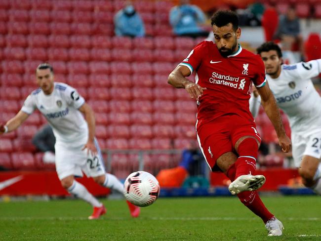 TOPSHOT - Liverpool's Egyptian midfielder Mohamed Salah scores their fourth goal, his third, from the penalty spot during the English Premier League football match between Liverpool and Leeds United at Anfield in Liverpool, north west England on September 12, 2020. - Liverpool won the game 4-3. (Photo by PHIL NOBLE / POOL / AFP) / RESTRICTED TO EDITORIAL USE. No use with unauthorized audio, video, data, fixture lists, club/league logos or 'live' services. Online in-match use limited to 120 images. An additional 40 images may be used in extra time. No video emulation. Social media in-match use limited to 120 images. An additional 40 images may be used in extra time. No use in betting publications, games or single club/league/player publications. /