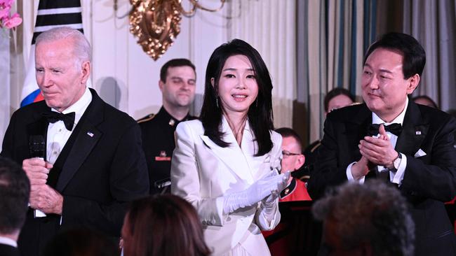 Joe Biden with South Korean President Yoon Suk-yeol (right) and his wife Kim Keon-hee in Washington this week, where as well as signing the pact, they sang karaoke. Picture: Brendan Smialowski/AFP