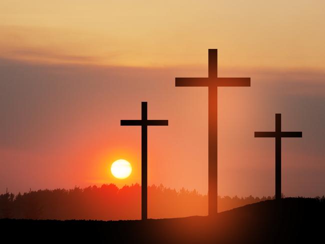 Christian cross on hill outdoors at sunrise. Resurrection of Jesus. Concept photo.