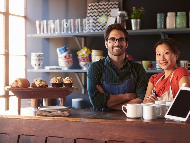 Portrait Of Couple Running Coffee Shop Behind Counter