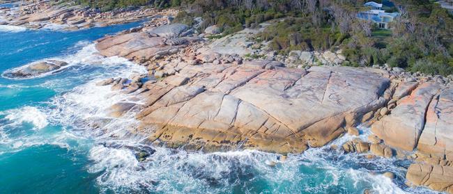 Perched atop the town's famous flame-coloured rocks, Cod Rock Point is perfect for an oceanfront stay at Bicheno, Tasmania