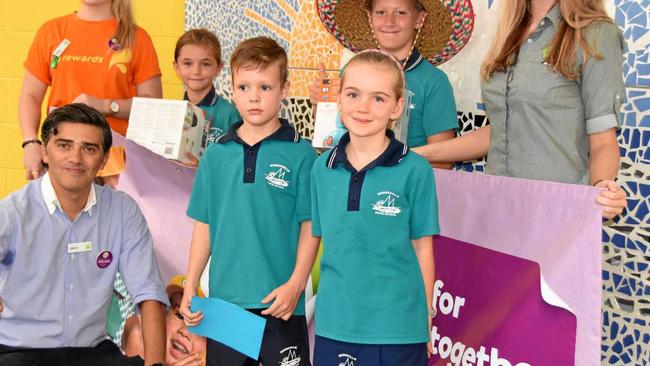 WELCOME VISIT: Woolworths' JaimeMauro, former pupils Chloe Crocker and Chelsea Newing with the bounty for Noosaville State School kids. Picture: Peter Gardiner