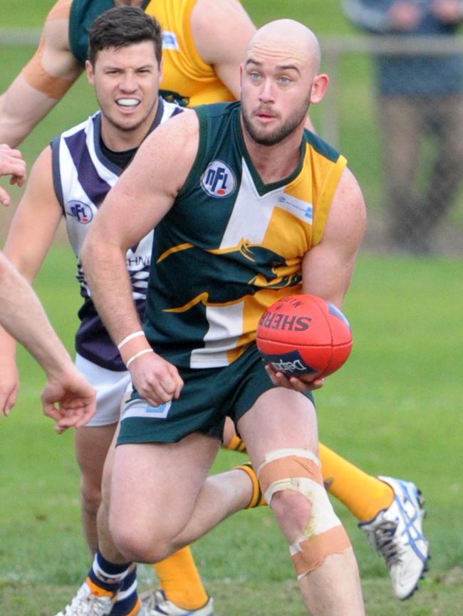 Northcote Park’s Bronik Davies handballs against Bundoora this year. Picture: Kylie Else.