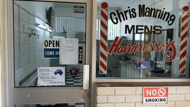 A barber shop in Nerang has a sign advising customers that his hours have been shortened due to the ‘China virus’