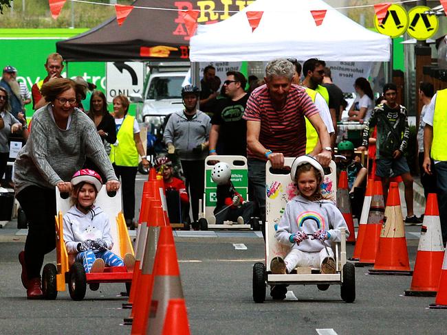 Scarlets Blume with nan Denise and Aria, pushed by grandad Steve, rush to the finish line.