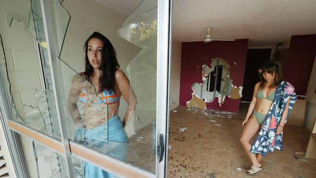 Backpackers Maria Steri, 25, and Alice Robinson Lake, 23, in one of the wrecked rooms at Great Keppel Island resort.