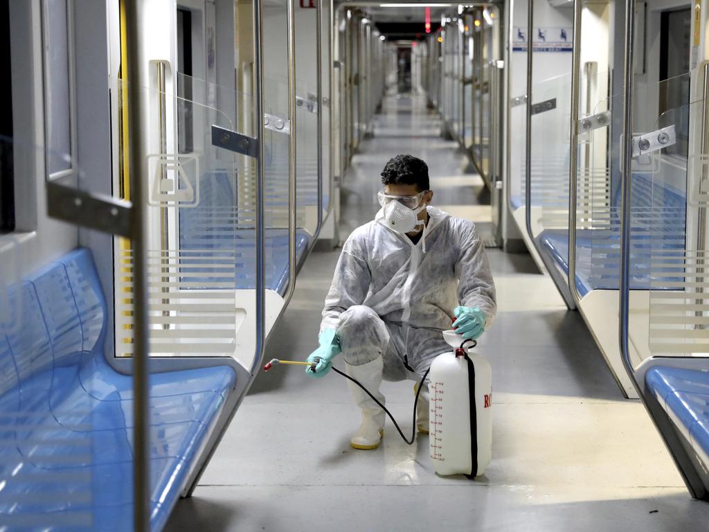 A worker disinfects subway trains against coronavirus in Tehran, Iran after more than a dozen people died from the coronavirus. Picture: Ebrahim Noroozi/AP