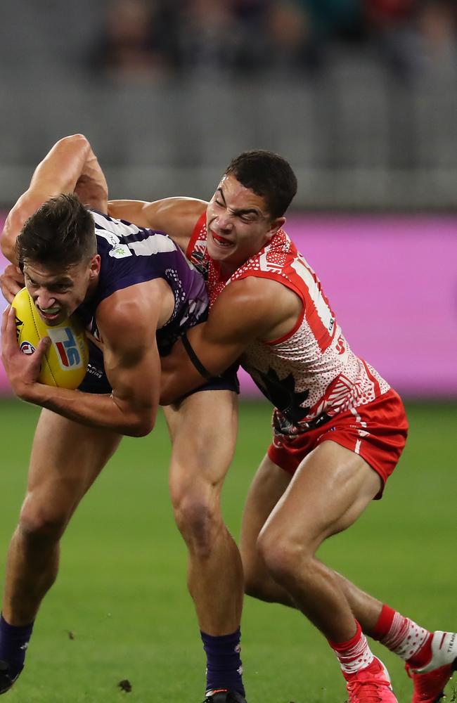 Zac Foot applying a tackle for the Sydney Swans.