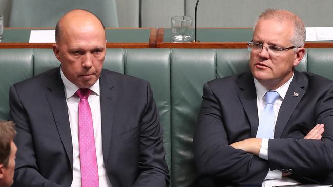 Home Affairs Minister Peter Dutton and PM Scott Morrison during a vote in the House of Representatives Chamber. Picture: Kym Smith