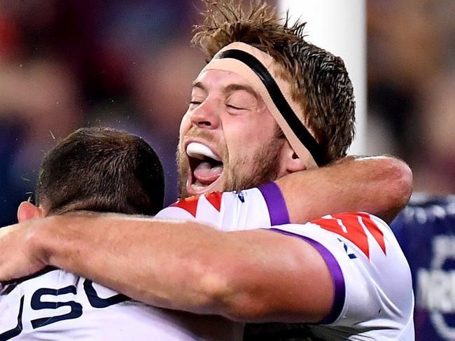 BRISBANE, AUSTRALIA - AUGUST 02: Christian Welch of the Storm celebrates with Cameron Smith after scoring a try during the round 20 NRL match between the Brisbane Broncos and the Melbourne Storm at Suncorp Stadium on August 02, 2019 in Brisbane, Australia. (Photo by Bradley Kanaris/Getty Images)