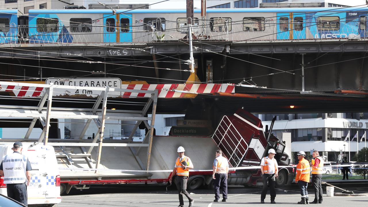 Cars, trams and trains were stopped with the truck beneath the bridge. The truck brought down tram power lines with routes still affected. Picture: AAP Image/David Crosling.