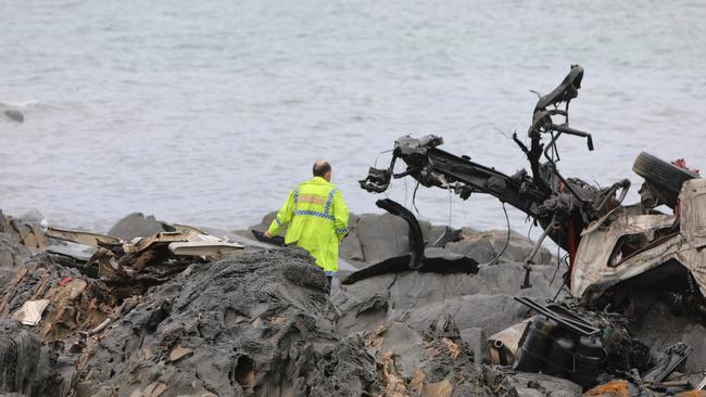 Police investigate the truck wreckage.