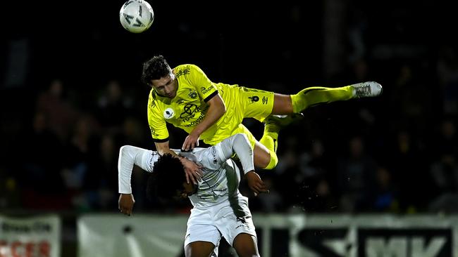 Moreton Bay’s Marquez Walters gives Anthony Theodoropoulos of Heidelberg United a piggyback ride.