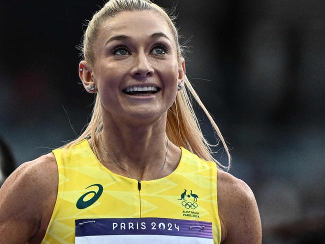 Australia's Jessica Hull and US' Nikki Hiltz react after competing in the women's 1500m semi-final of the athletics event at the Paris 2024 Olympic Games at Stade de France in Saint-Denis, north of Paris, on August 8, 2024. (Photo by Jewel SAMAD / AFP)