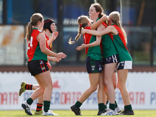 MELBOURNE, AUSTRALIA - JULY 28: Charli Hoey of Clonard College celebrates a goal with teammates. Picture: Dylan Burns/AFL Photos via Getty Images)