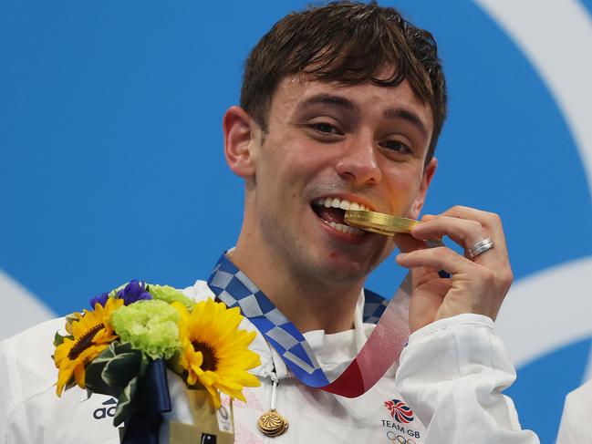 TOKYO, JAPAN - JULY 26: Tom Daley of Team Great Britain poses with the gold medal during the medal presentation for the Men's Synchronised 10m Platform Final on day three of the Tokyo 2020 Olympic Games at Tokyo Aquatics Centre on July 26, 2021 in Tokyo, Japan. (Photo by Clive Rose/Getty Images)