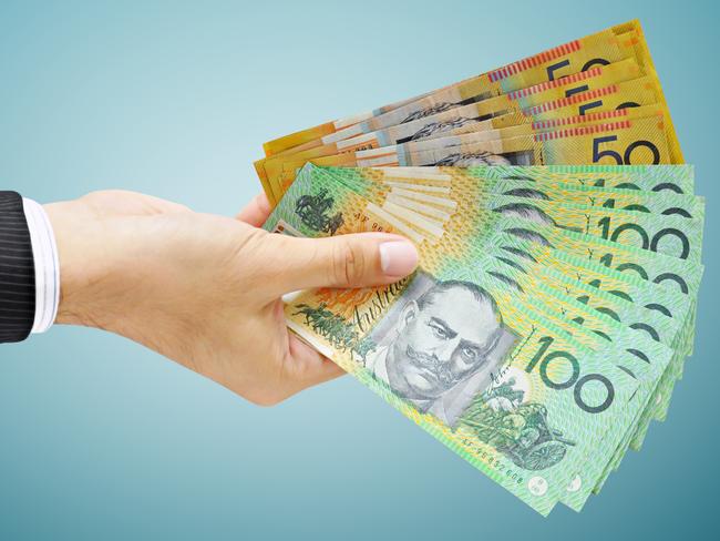 Hand holding money - Australian dollar (AUD) bills