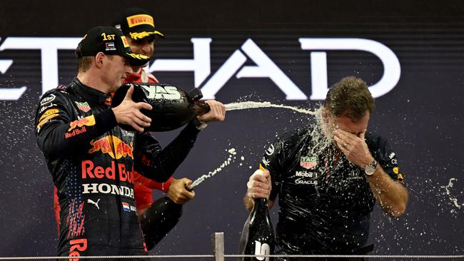 Verstappen showers Christian Horner in champagne. Photo by ANDREJ ISAKOVIC / POOL / AFP