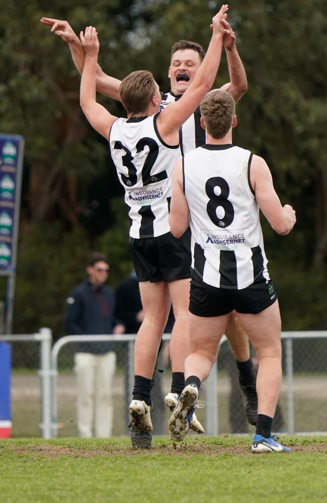 Riley Siwes (No. 32), Hayden Dwyer and Will Howe (No. 8) celebrate a goal. Picture: Valeriu Campan