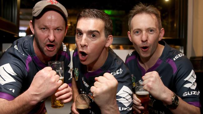 Lap it up, Sydney: Melbourne Storm supporters Sean Van Tongeren, Andrew Spinelli, and Glen Jones get in the mood in a George St bar.