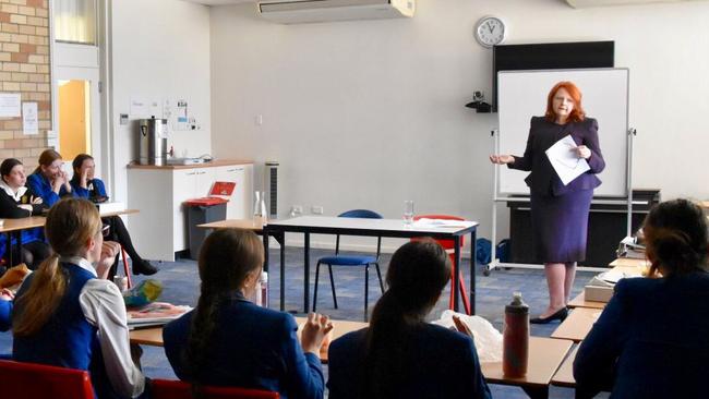 Julia Lonergan, pictured speaking with legal studies students at her former school, Loreto Kirribilli.